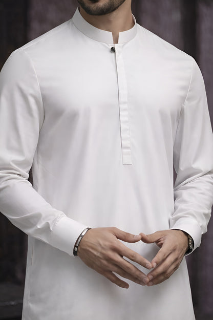 White long-sleeve shirt worn by a person with a blurred background